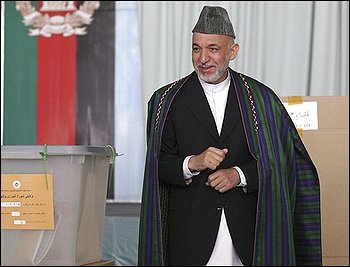 Afghan presidential candidate and current President Hamid Karzai walks away after casting his vote at a polling station in Kabul, Afghanistan, Thursday, Aug. 20, 2009. Thousands of polling centers across Afghanistan opened for voting Thursday, and millions of Afghans were expected to choose a new president to lead a nation plagued by armed insurgency, drugs, corruption and a feeble government. (AP Photo/Rafiq Maqbool)